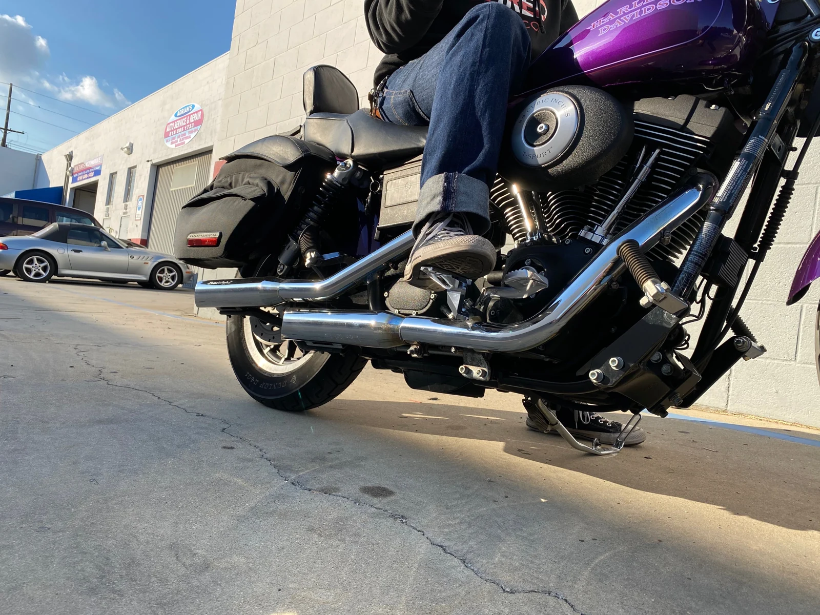 Rider's boot on original Shred Pegs installed on a V-twin motorcycle