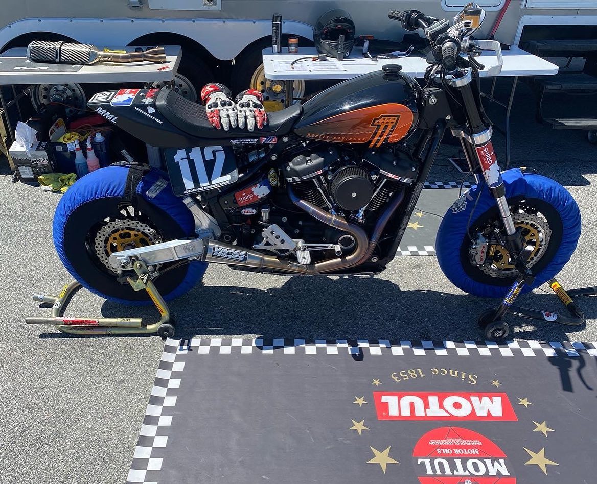 Shred Moto race bike number 112 on tire warmers in the paddock